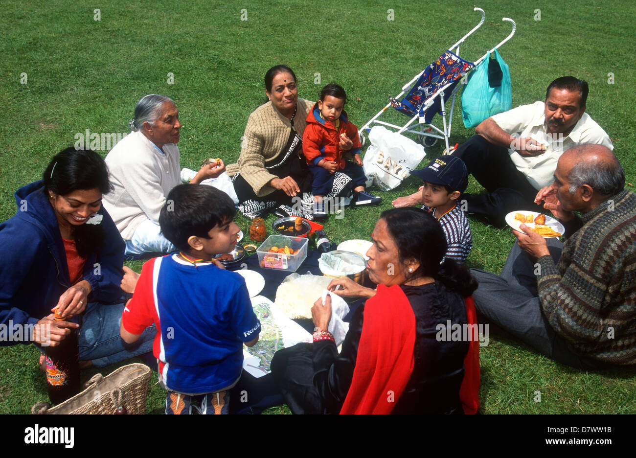 Asian family enjoying a picnic in a London park, UK. Stock Photo