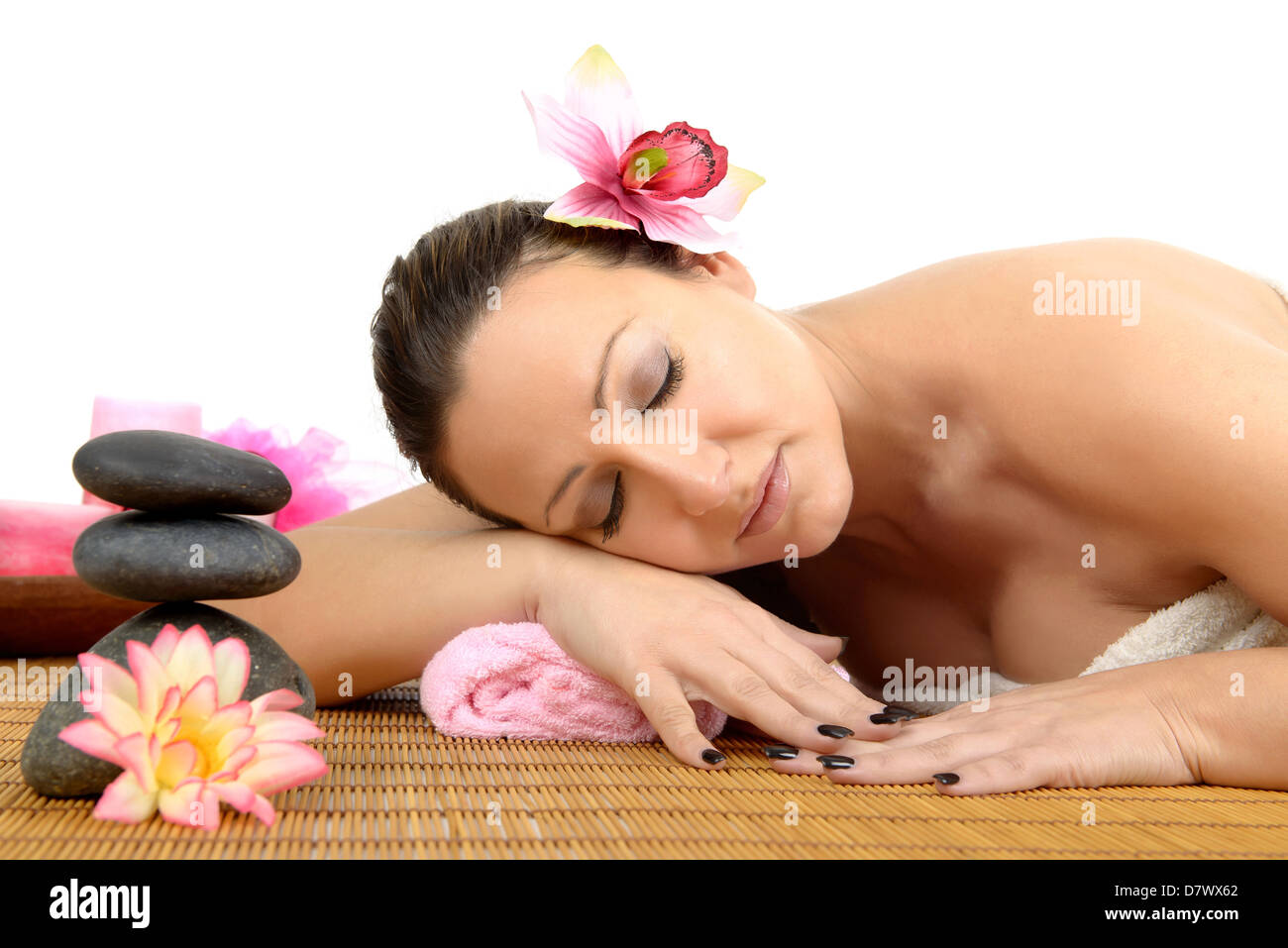 Beautiful woman in a stone massage at beauty spa salon. Recreation therapy. Stock Photo