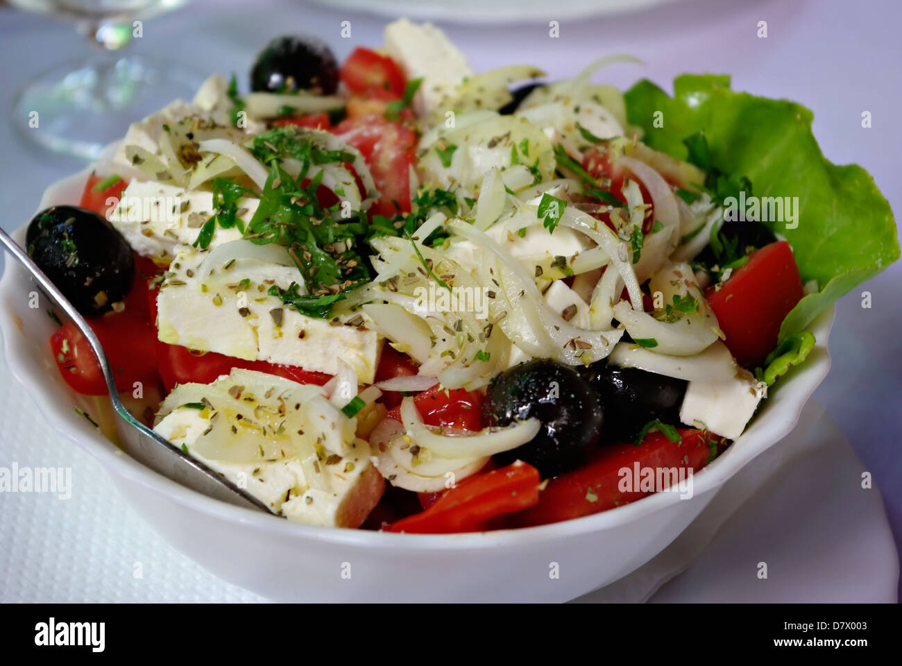 Traditional greek salad consists of tomato, onion, olives cheese and