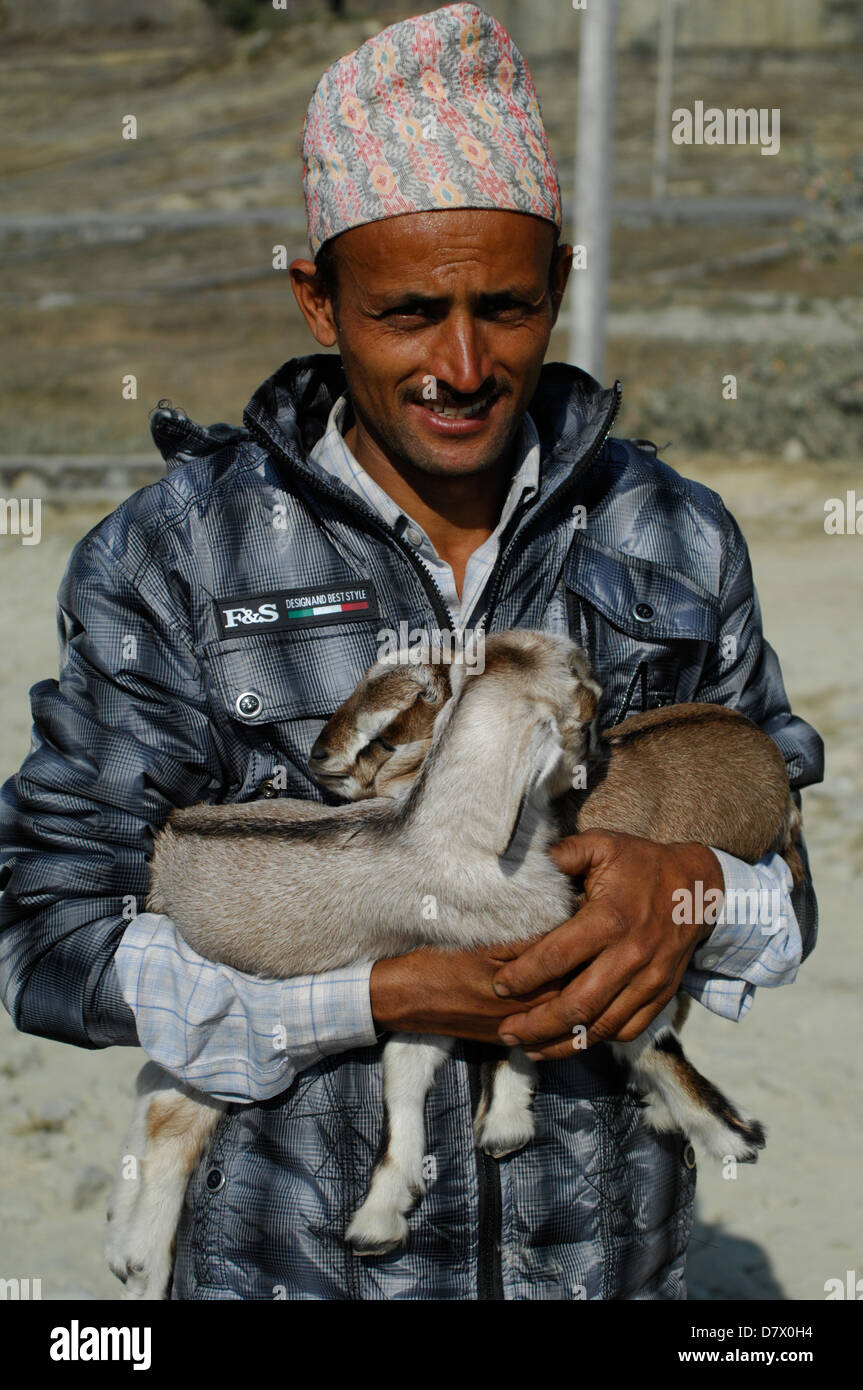 A rural farmer in Nepal with a goat. Two goats. Stock Photo
