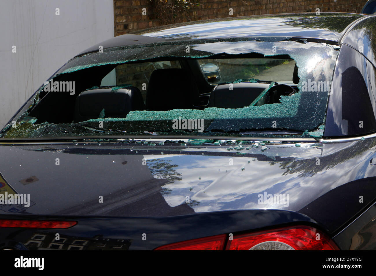 Rear windscreen of car smashed up, window broken into by thieves, robbery, vandalism Stock Photo