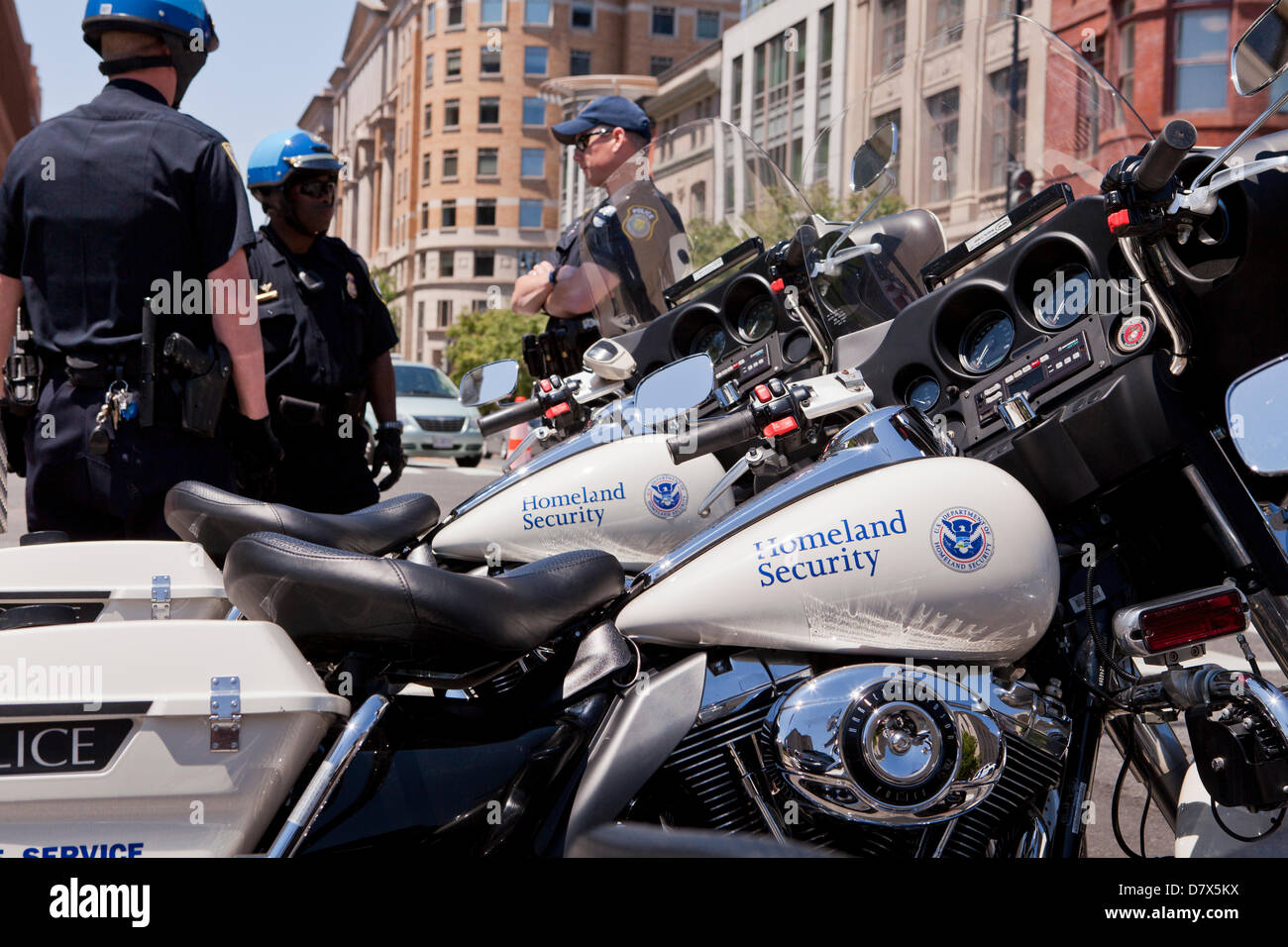 US Department of Homeland Security Federal Protective Service Police officers standing next to service motorcycle Stock Photo