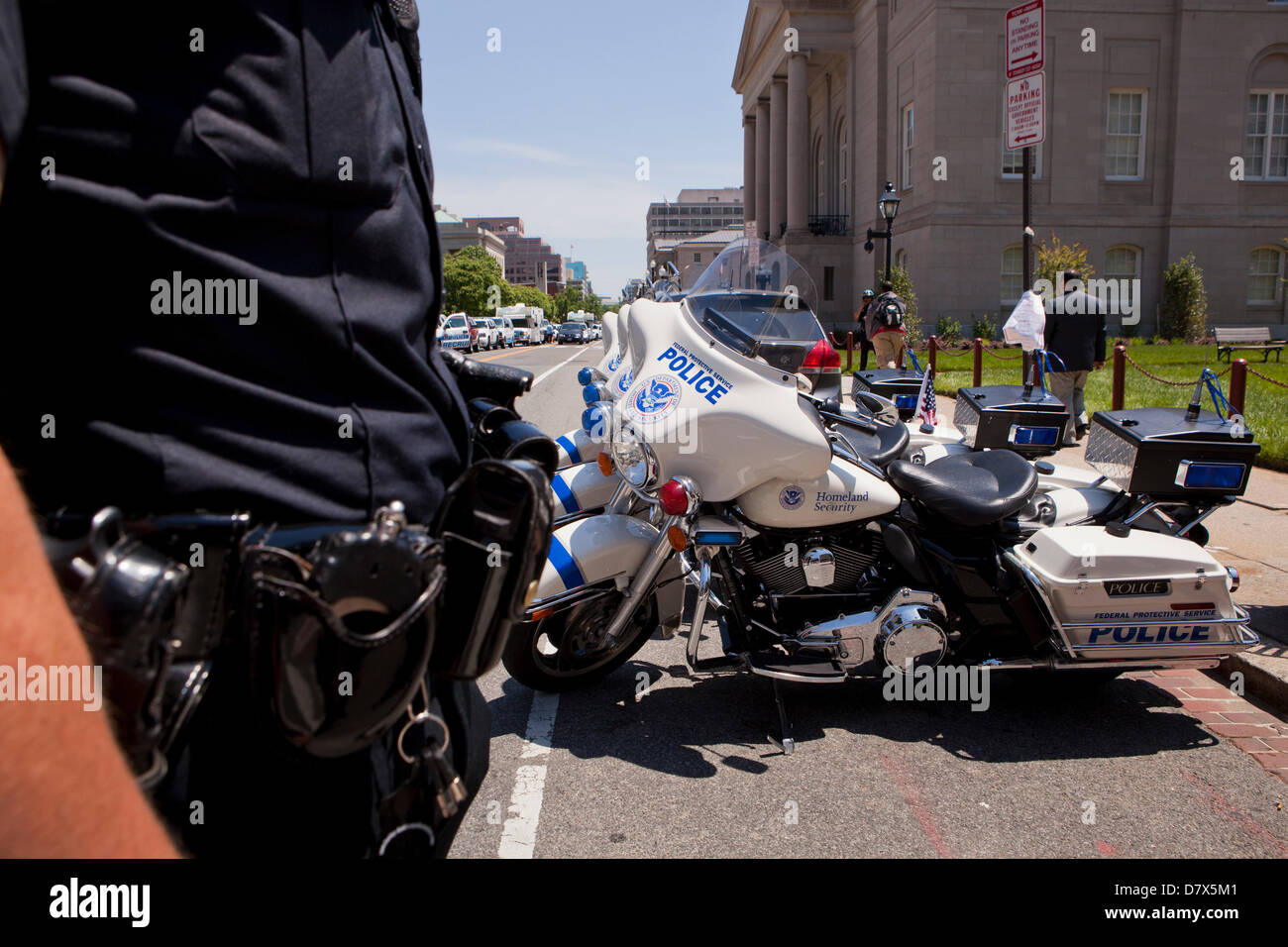 US Department of Homeland Security Federal Protective Service Police officer standing next to service motorcycle - Washington, DC USA Stock Photo