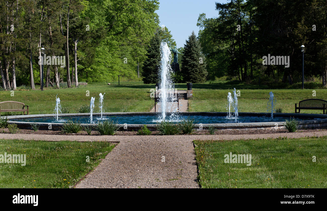 Reflecting wading pool with seven shooting water fountains in a