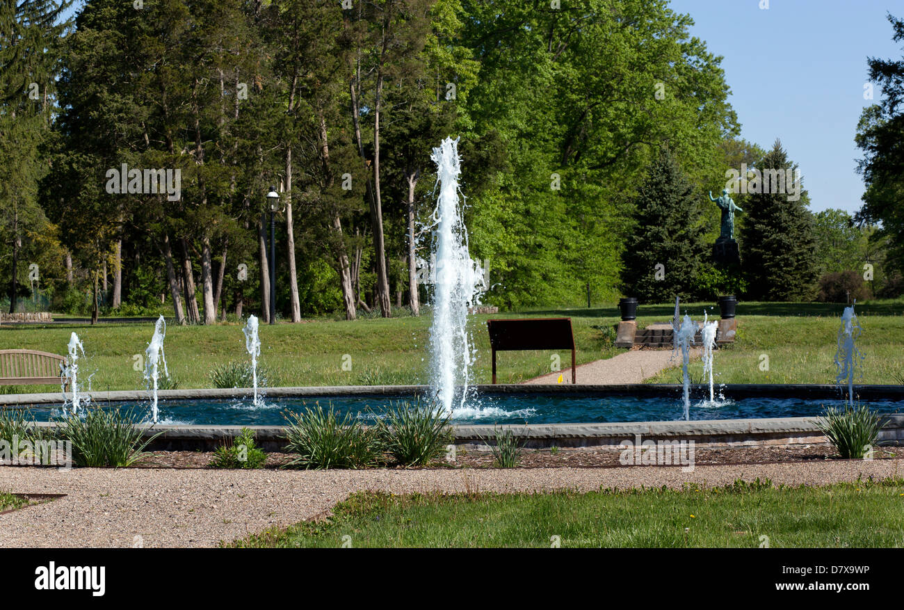 Reflecting wading pool with seven shooting water fountains in a