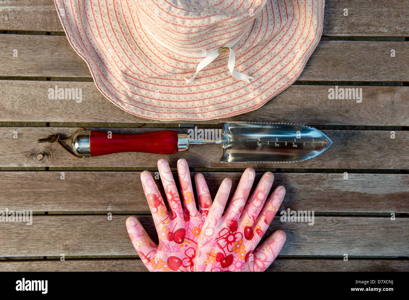 Arrangement of gardening tools - sun hat, gloss, and trowel Stock Photo