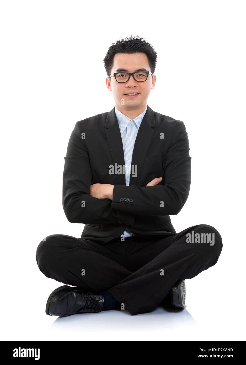 Full body portrait of happy smiling Asian business man sitting on floor ...
