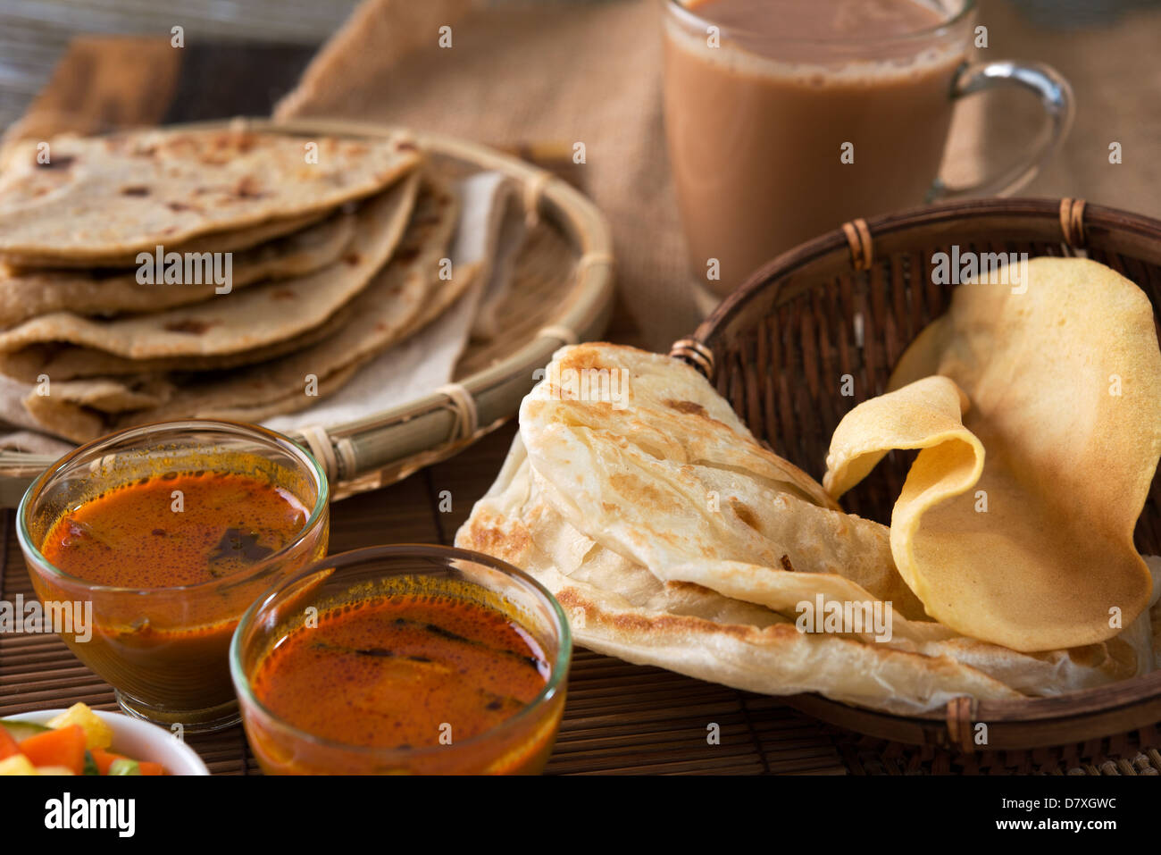 Roti canai, Chapati or Flat bread, teh tarik or milk tea and curry, famous Malaysian Indian food. Stock Photo