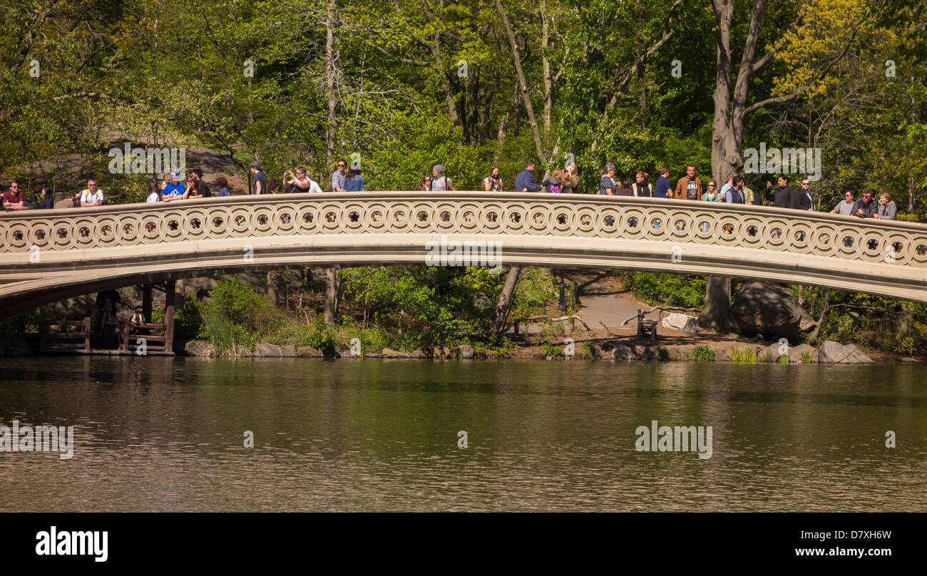 NEW YORK CITY, NY, USA - People at Bow Bridge and The Lake, in Central Park Stock Photo