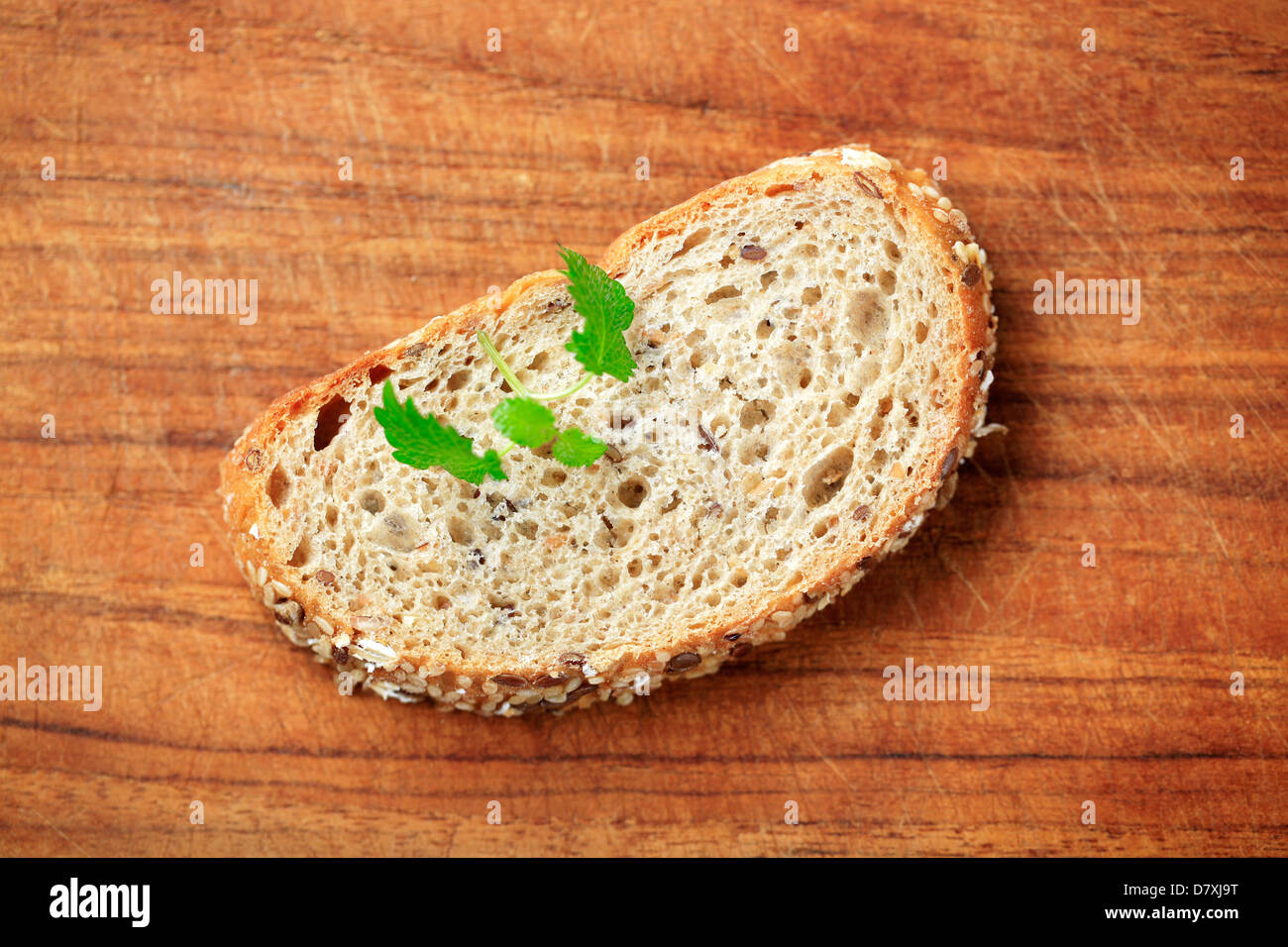 Slice of whole grain bread on a cutting board Stock Photo - Alamy