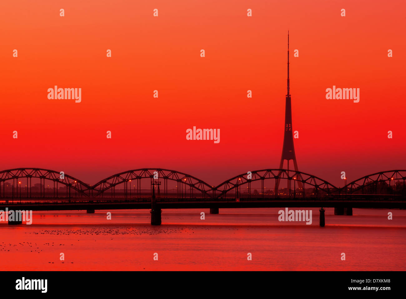 Riga Radio and TV Tower with famous railway bridge at sunset Stock Photo