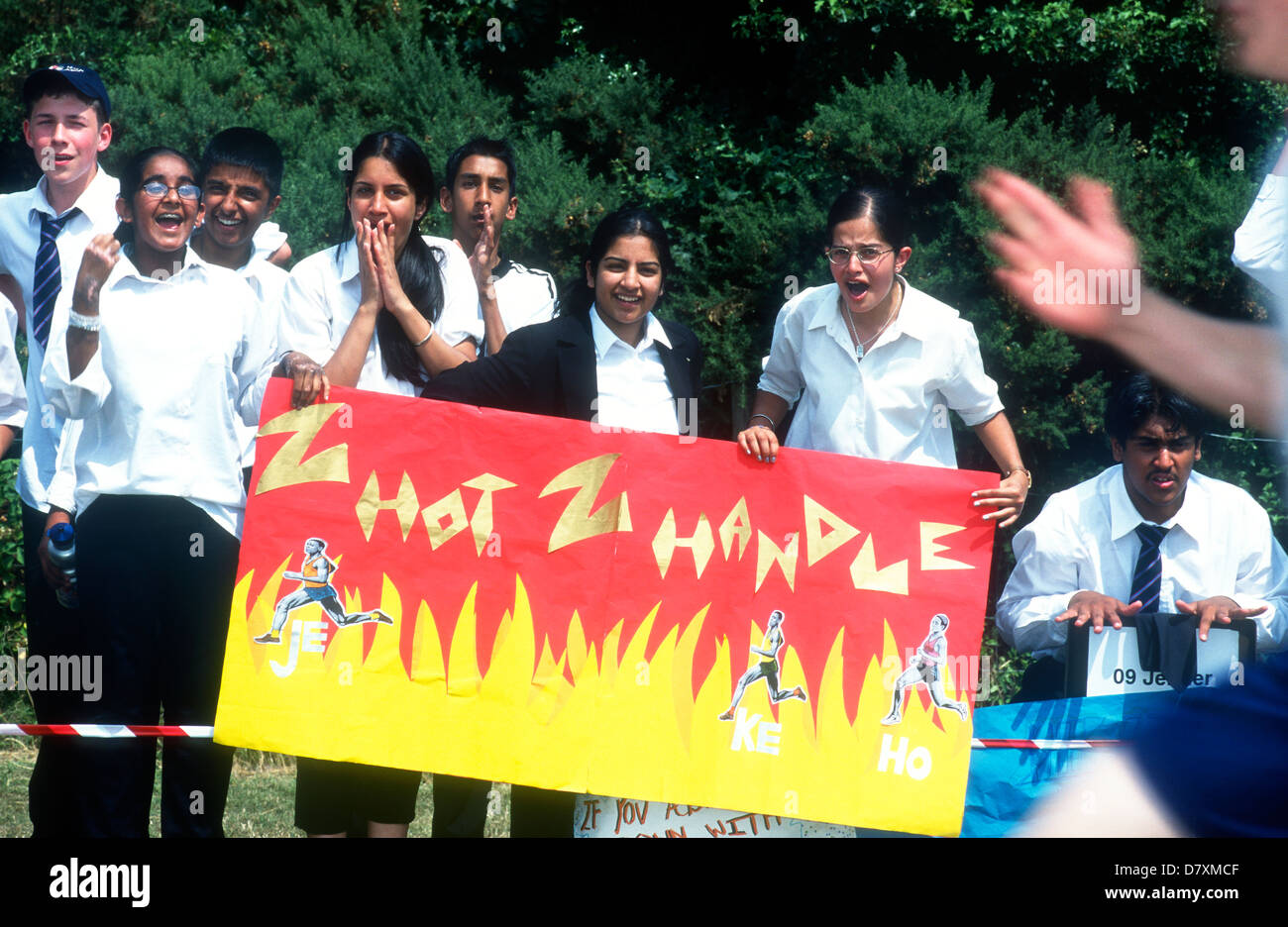 Pupils cheering on their peers during school sports day, Heathland Secondary School, Hounslow, Middlesex, UK. Stock Photo