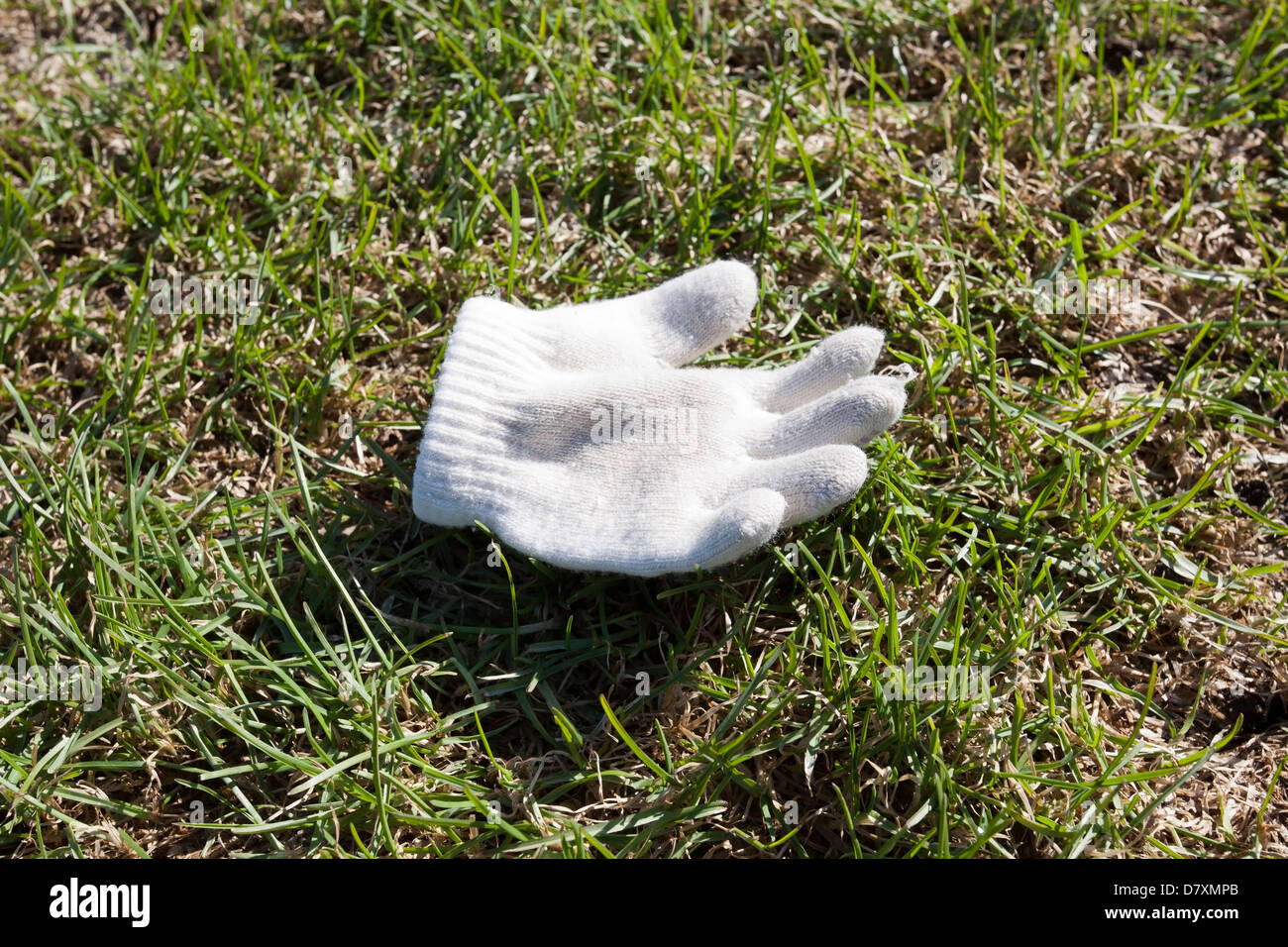 child´s glove on ground Stock Photo