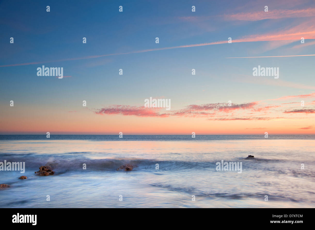 Stunning Summer sunset over ocean with rocks and vibrant colors Stock ...
