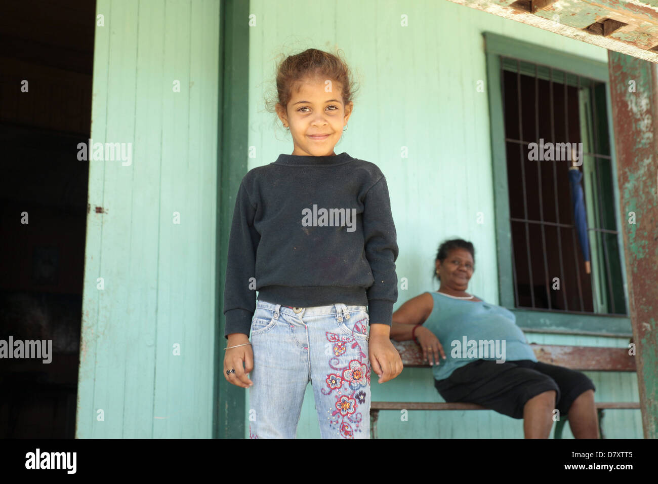 daughter and mother in front of their home on the island Cayo Granma, island near Santiago de Cuba, Cuba, Carribean Stock Photo