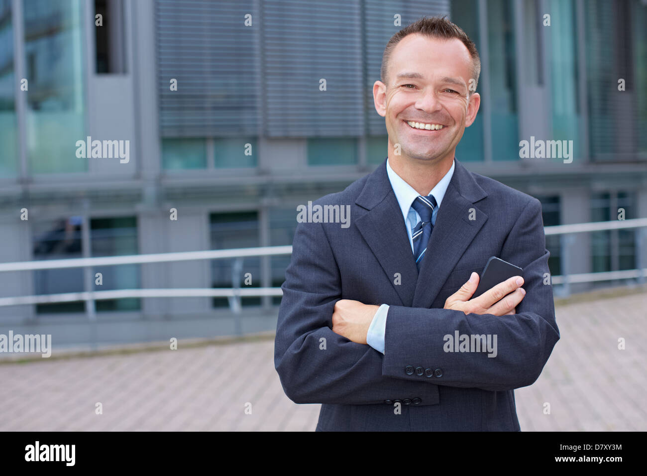 Portrait of a smiling business man with his arms crossed Stock Photo ...