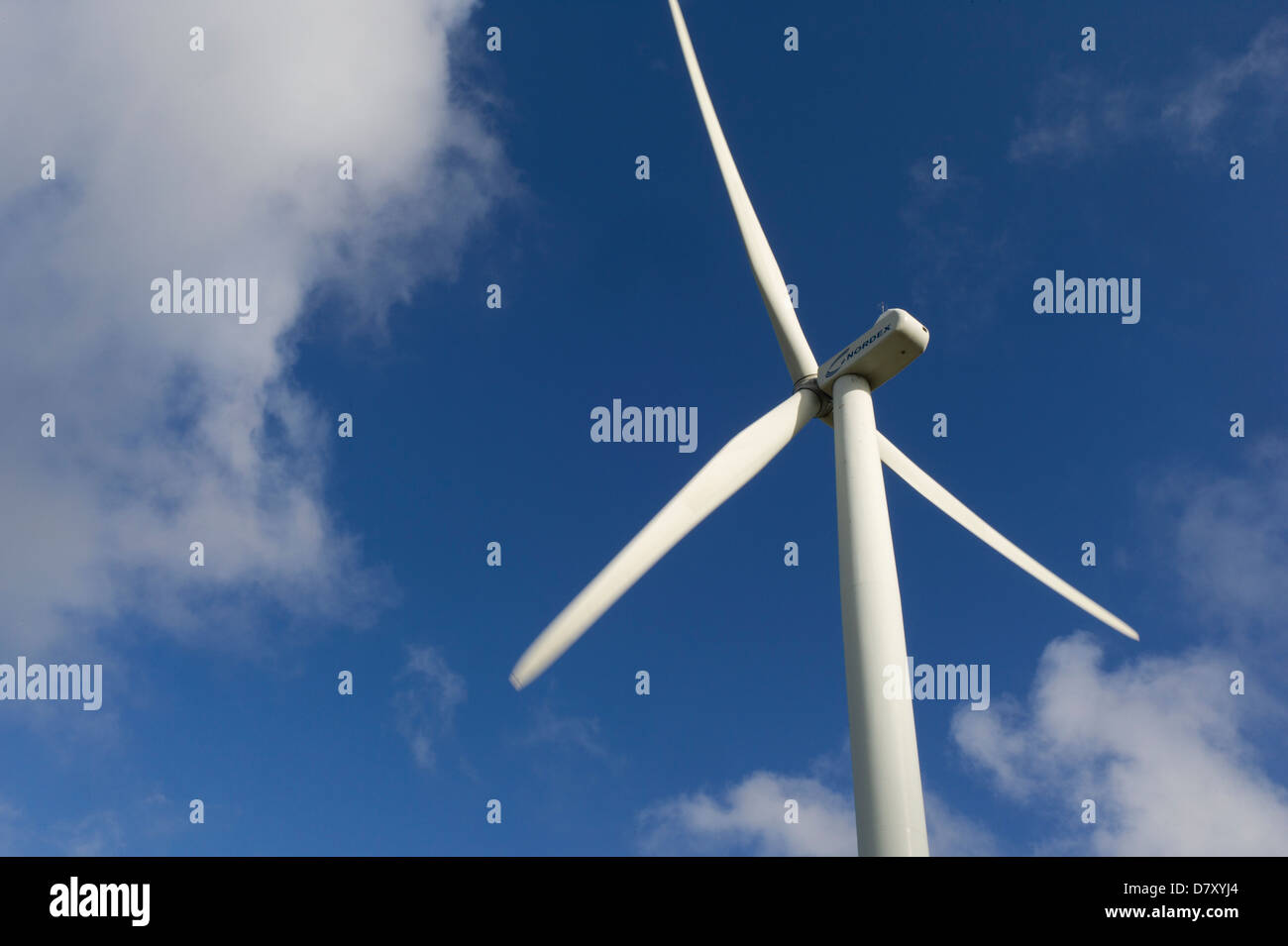 Wind turbine vanes against blue sky and clouds Stock Photo
