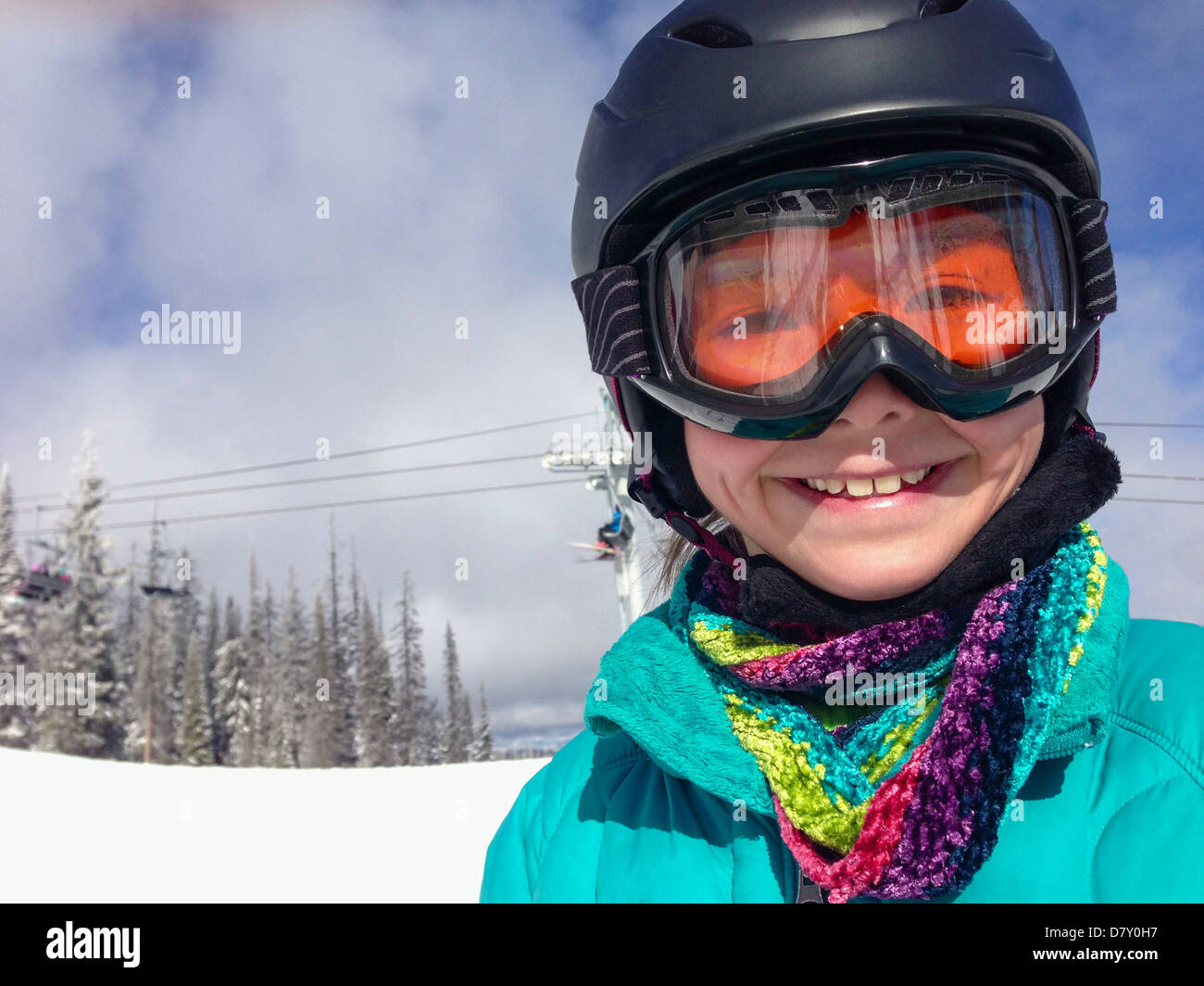 Mixed race girl wearing ski gear on mountain - Smartphone Captured Stock Image