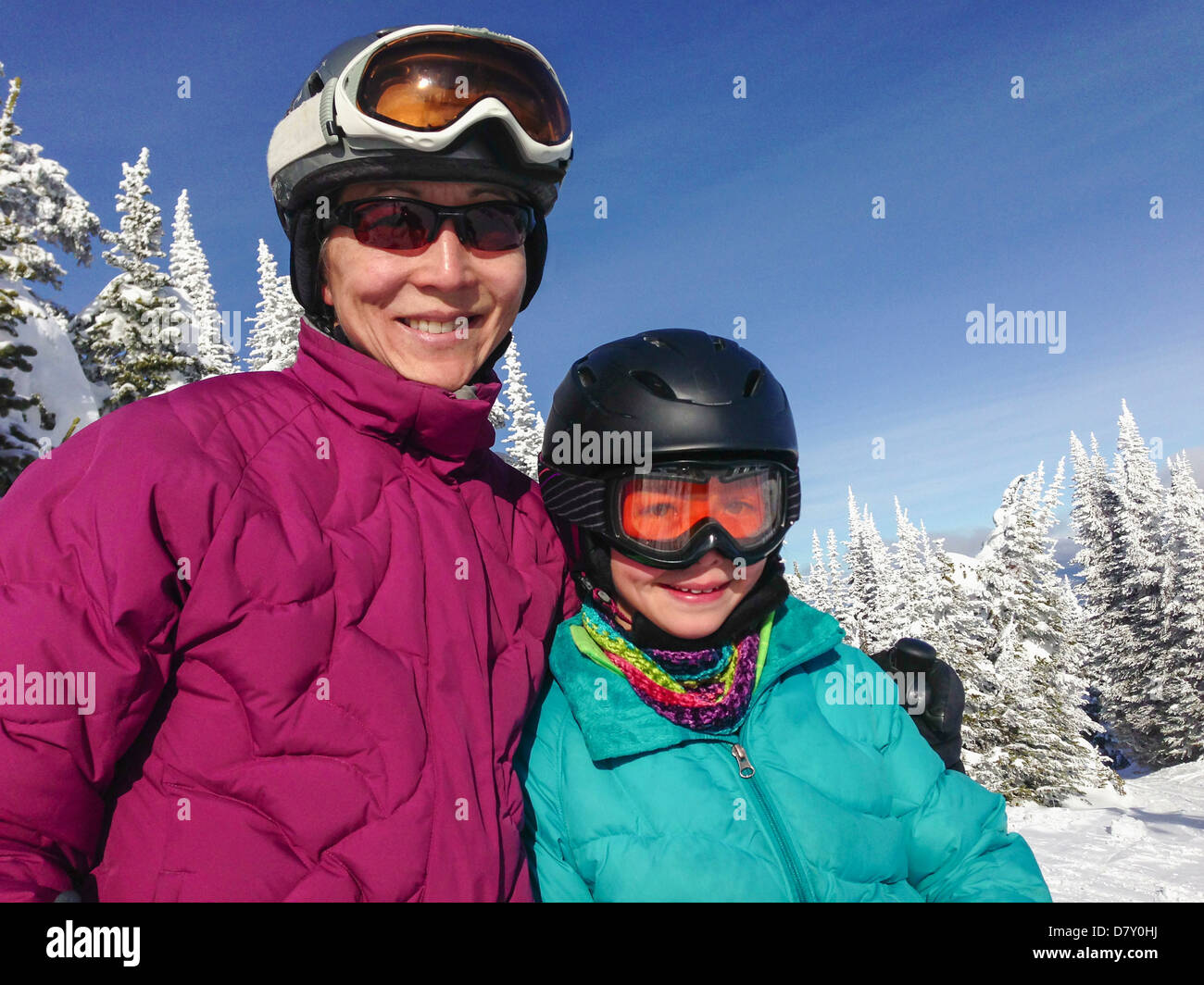 Mother and daughter wearing ski gear outdoors - Smartphone Captured Stock Image