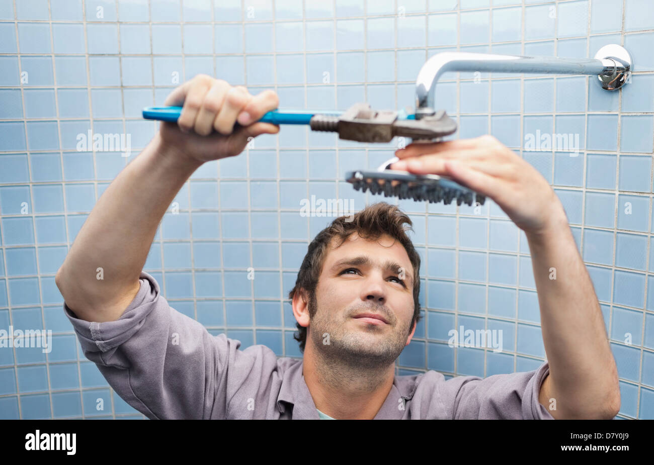 Plumber working on shower head in bathroom Stock Photo Alamy