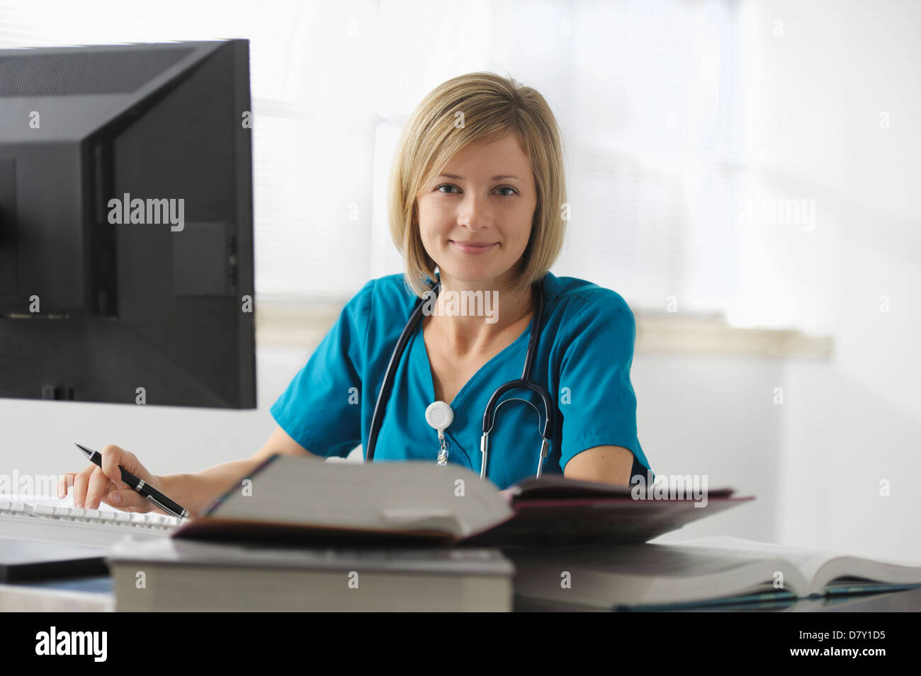 Surgeon Using A Computer Caucasian surgeon reading books and using computer Stock Photo - Alamy