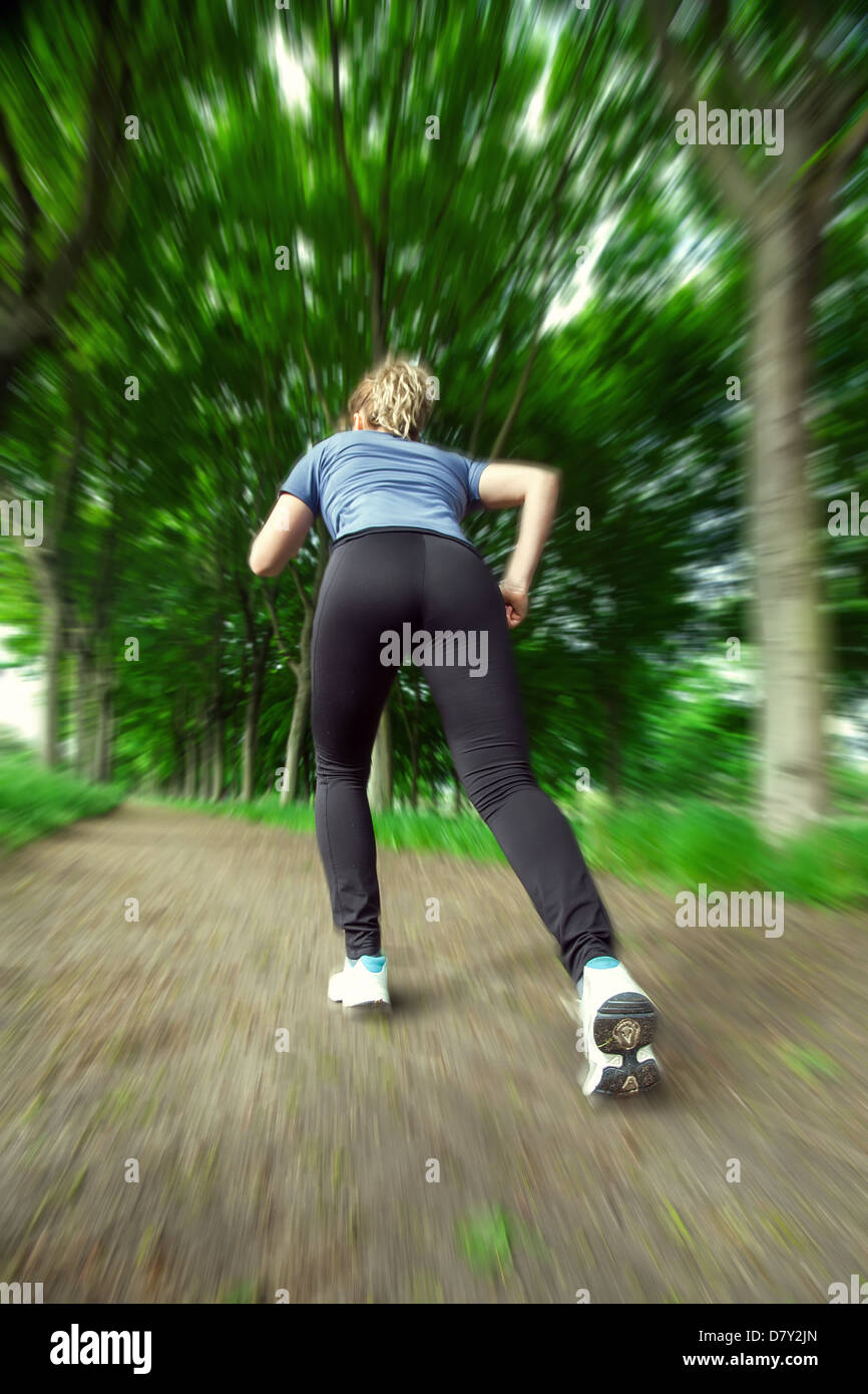 A young woman quickly runs into the forest Stock Photo - Alamy