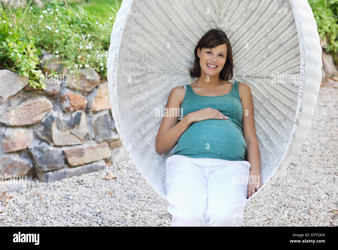 Pregnant woman relaxing outdoors Stock Photo