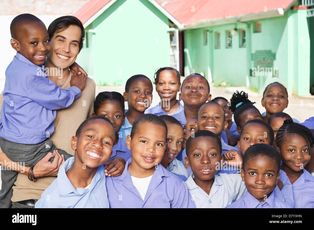 Students and teacher smiling outdoors Stock Photo