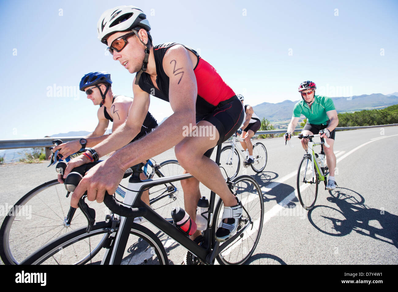 Cyclists in race on rural road Stock Photo