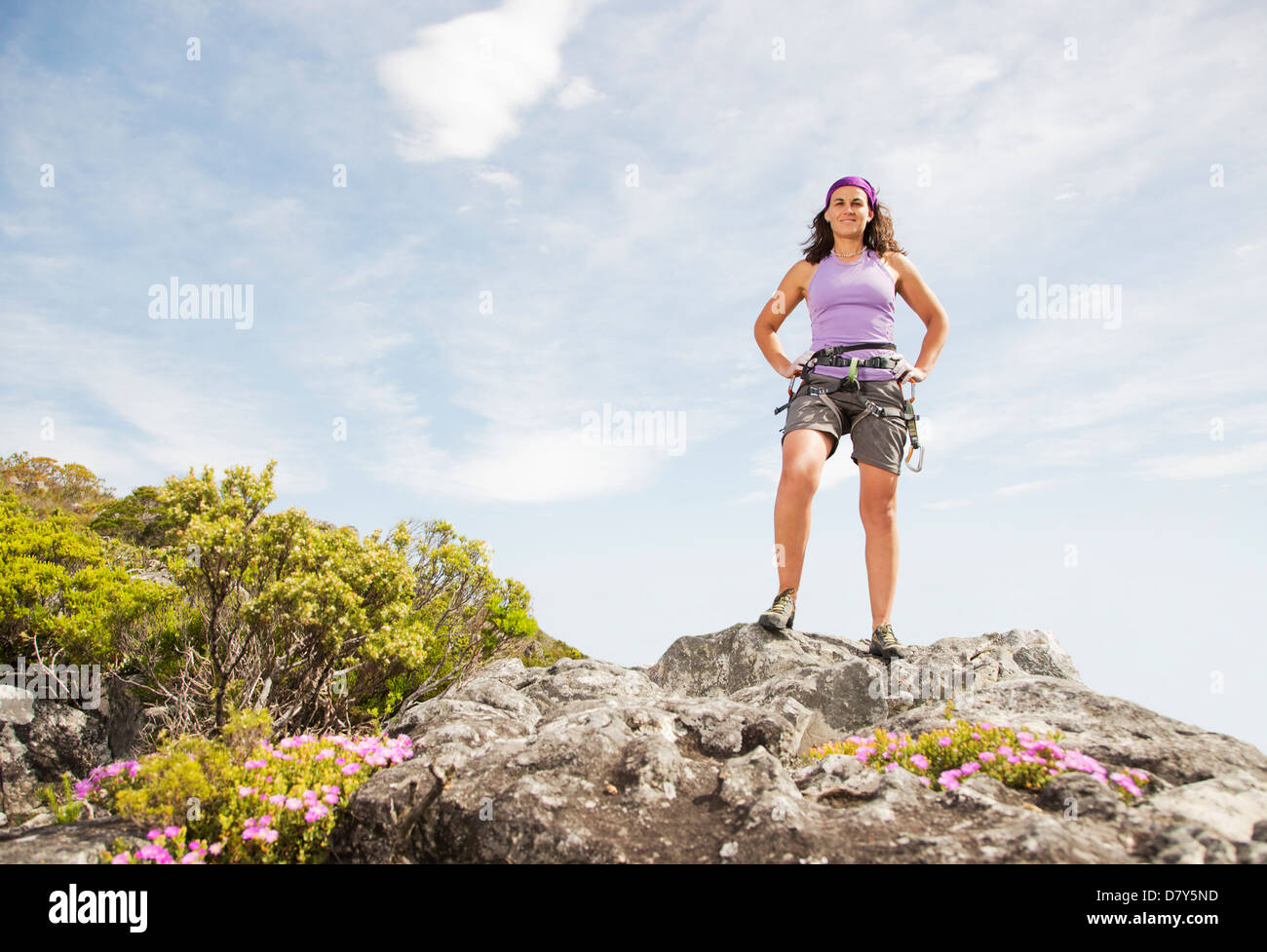 Climber standing on rocky hilltop Stock Photo