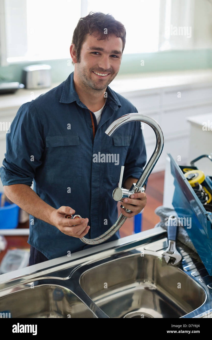 Plumber working on kitchen sink Stock Photo Alamy