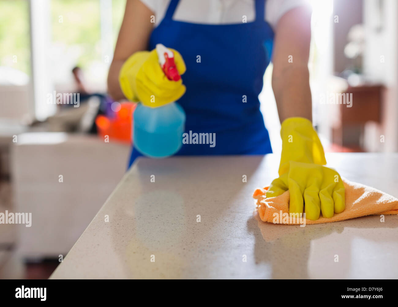 Woman cleaning kitchen counter Stock Photo