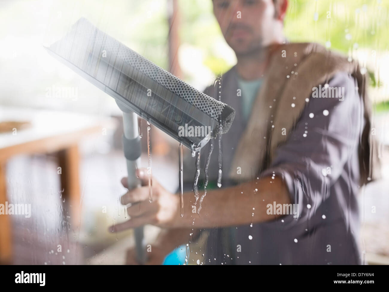 Man washing window with squeegee Stock Photo Alamy