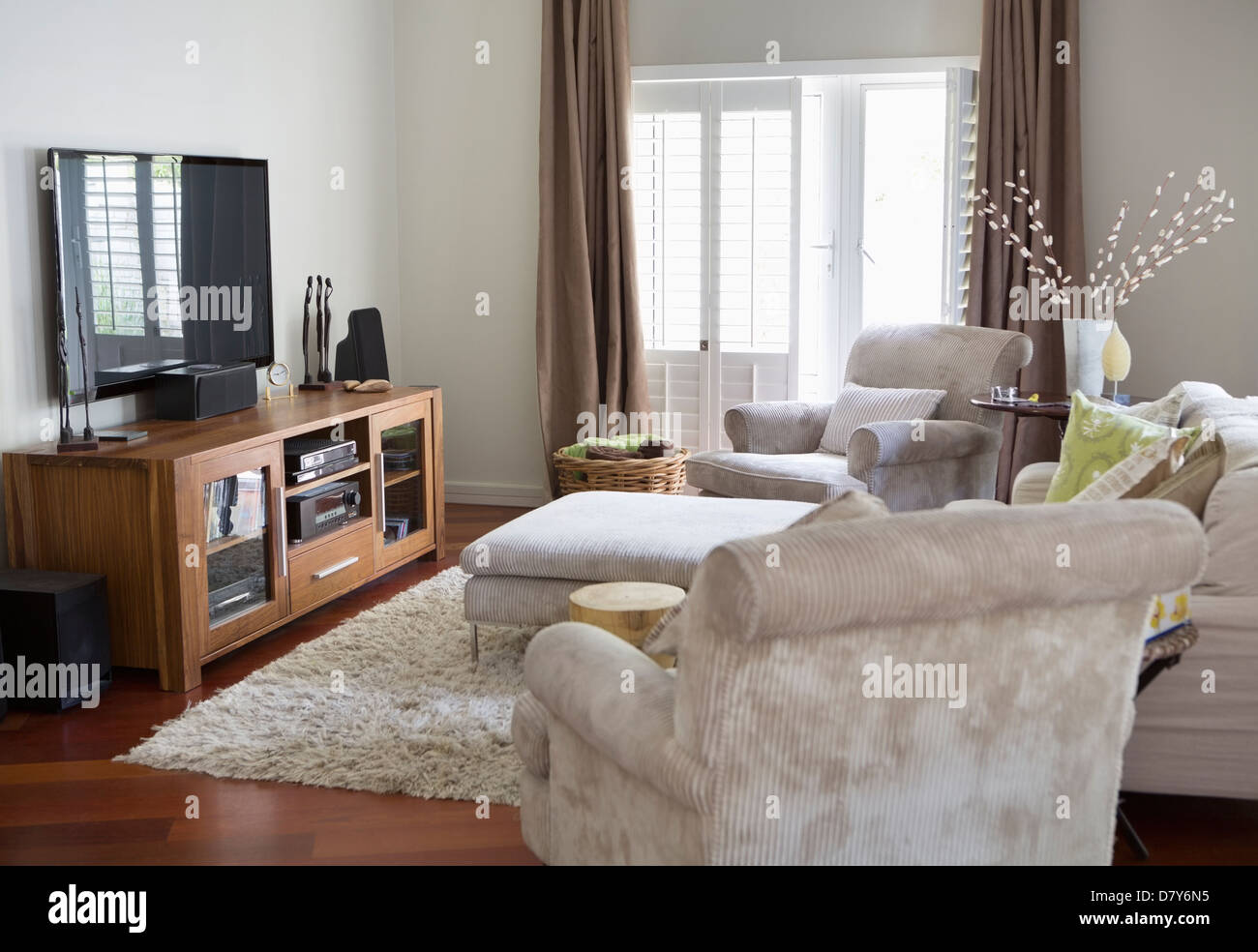 Television and armchairs in living room Stock Photo Alamy