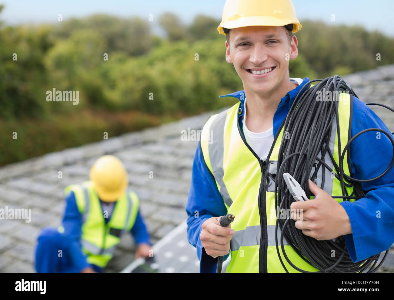 Worker smiling on rooftop Stock Photo