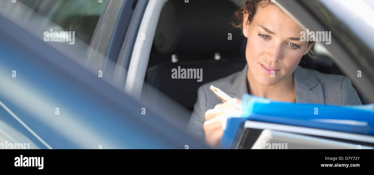 Businesswoman working in car Stock Photo