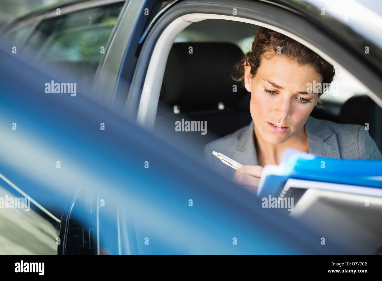 Businesswoman working in car Stock Photo Alamy