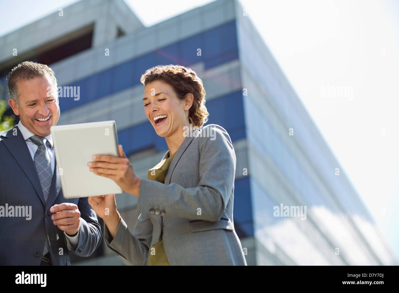 Business people using tablet computer outdoors Stock Photo