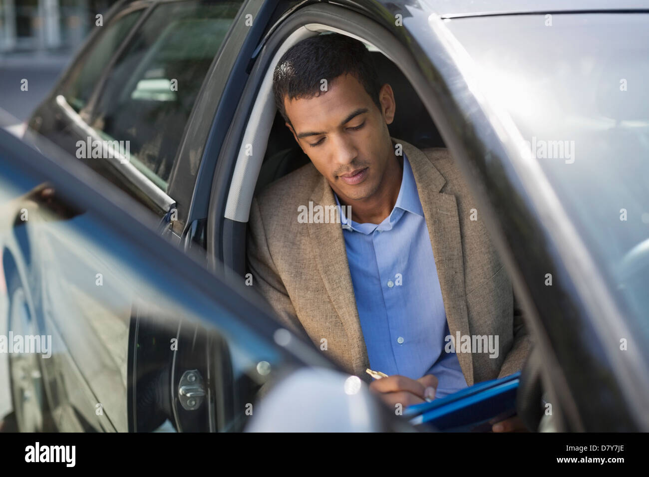 Businessman working in car Stock Photo