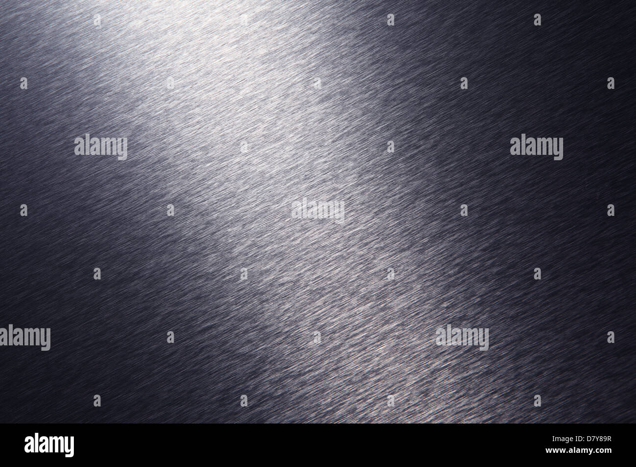 A close-up view of a brushed stainless steel surface with dramatic lighting. Stock Photo