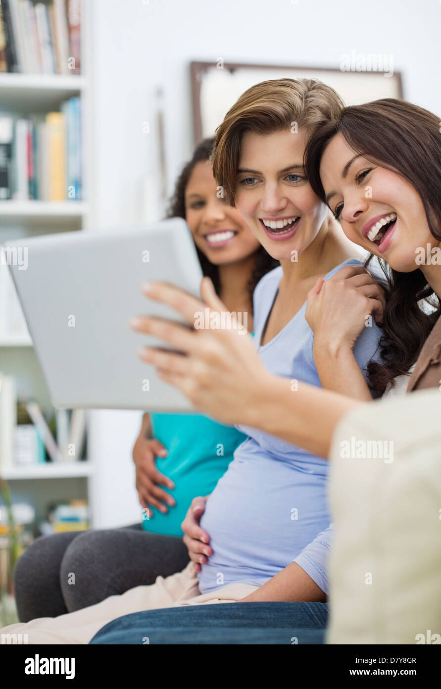Women using tablet computer together Stock Photo