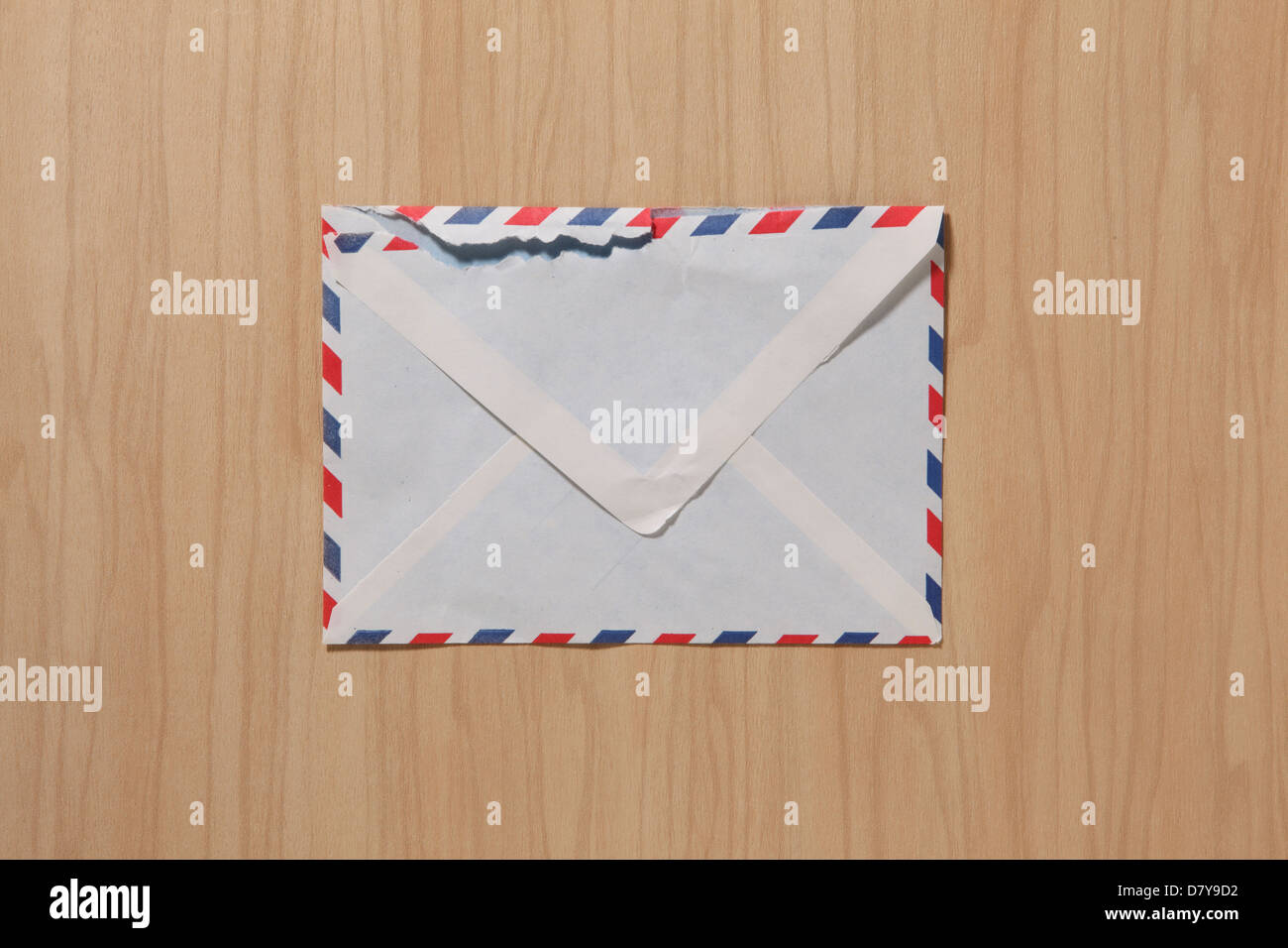 An air mail envelope slightly worn and torn. Stock Photo