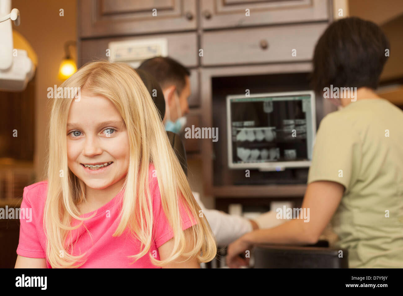Girl with braces smiling in dentist's office Stock Photo Alamy