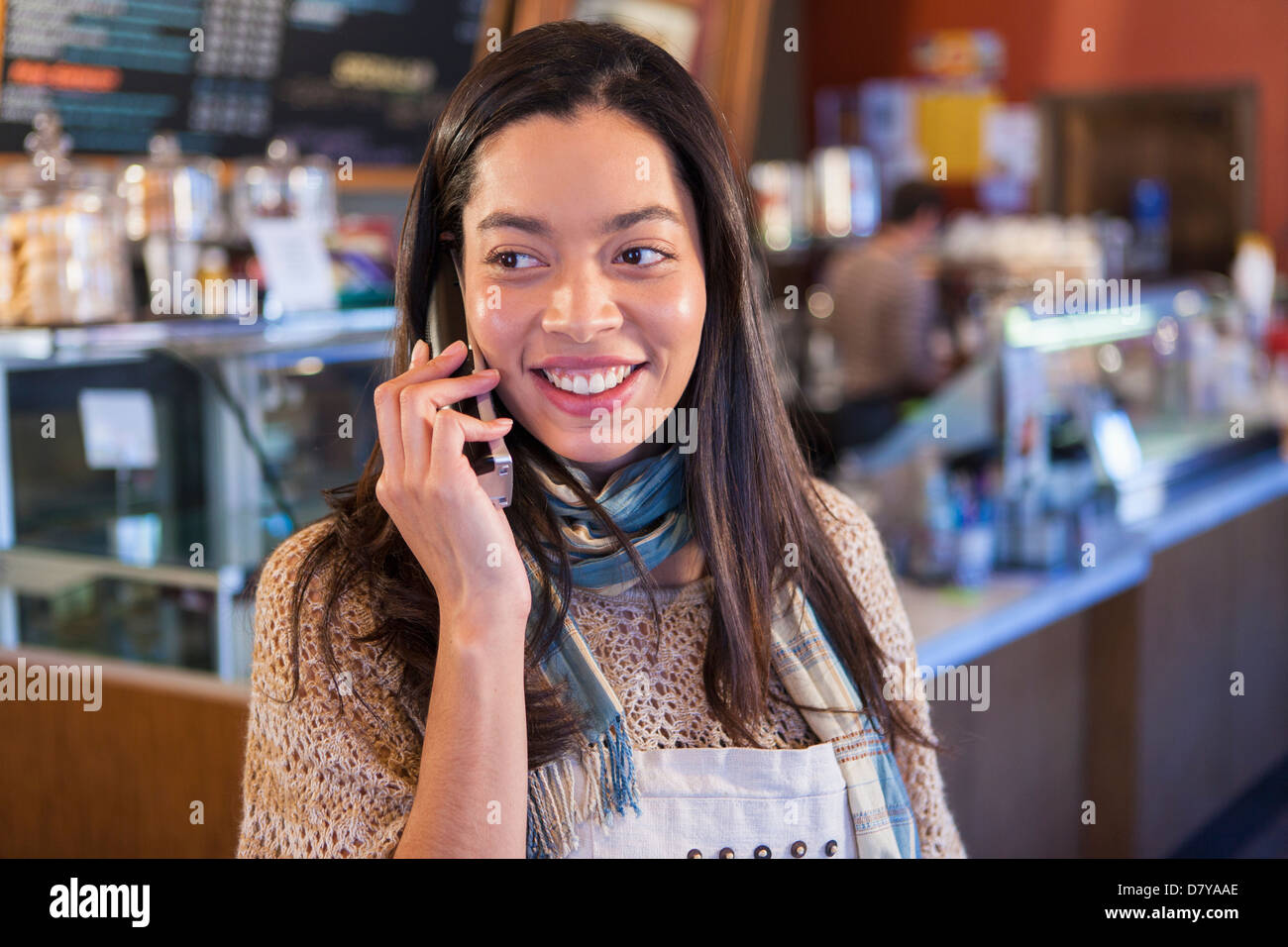 Mixed race woman on telephone in coffee shop Stock Photo Alamy