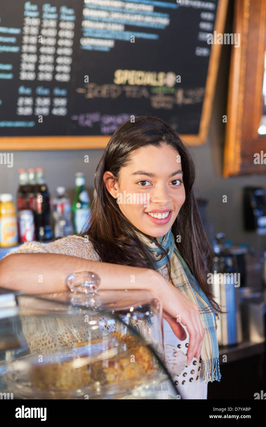 Mixed race woman working in coffee shop Stock Photo Alamy