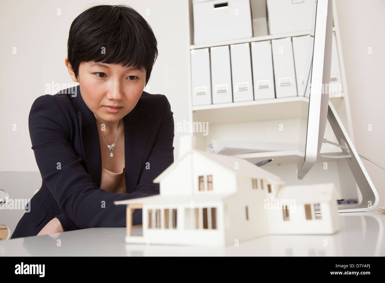 Businesswoman working on model in office Stock Photo - Alamy