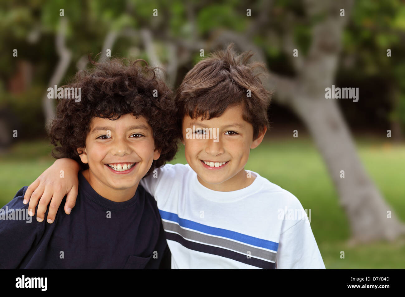 Two smiling happy young mixed race boys outside Stock Photo