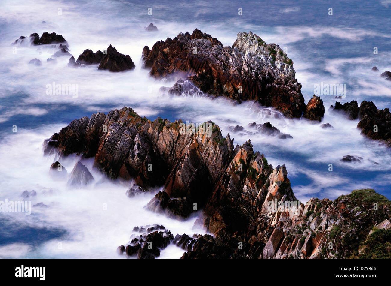 Spain, Asturias: Waves and rocks at the coast of fisher village Cudillero  seen from the lighthouse Stock Photo