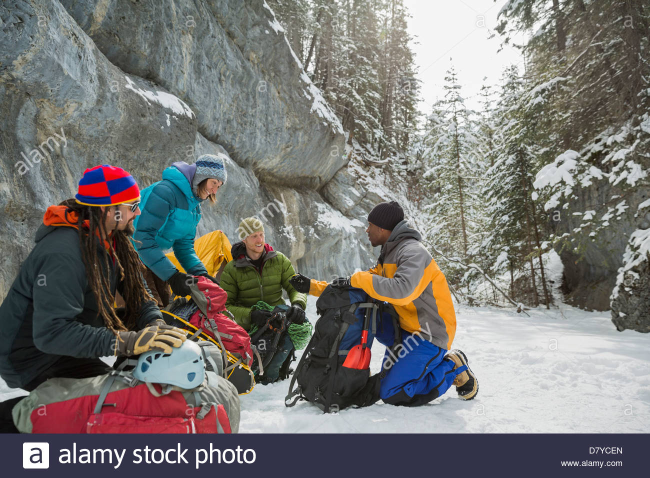 Group of friends on winter hike in mountains Stock Photo