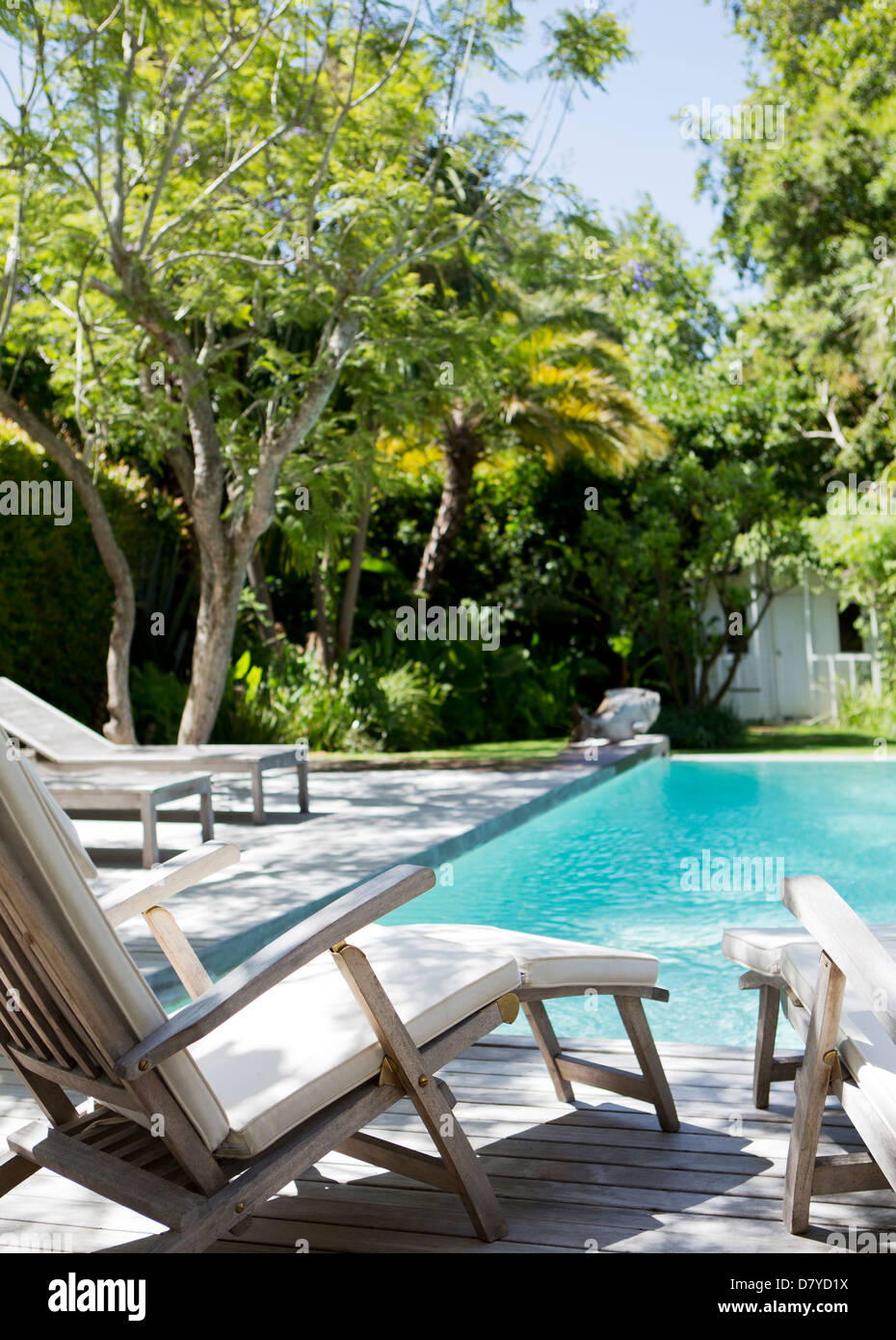 Lawn chairs and swimming pool in backyard Stock Photo Alamy